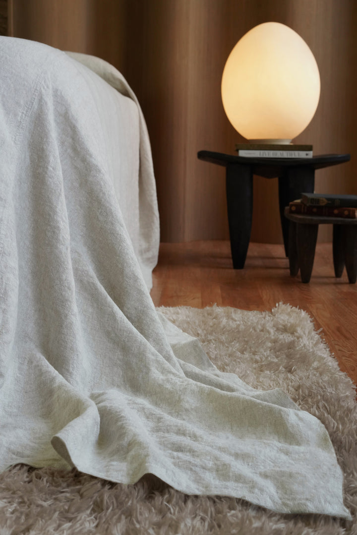 Dramatic floor-length puddle drape on a 124x128 oversized linen bedspread, hiding the bed frame and box spring