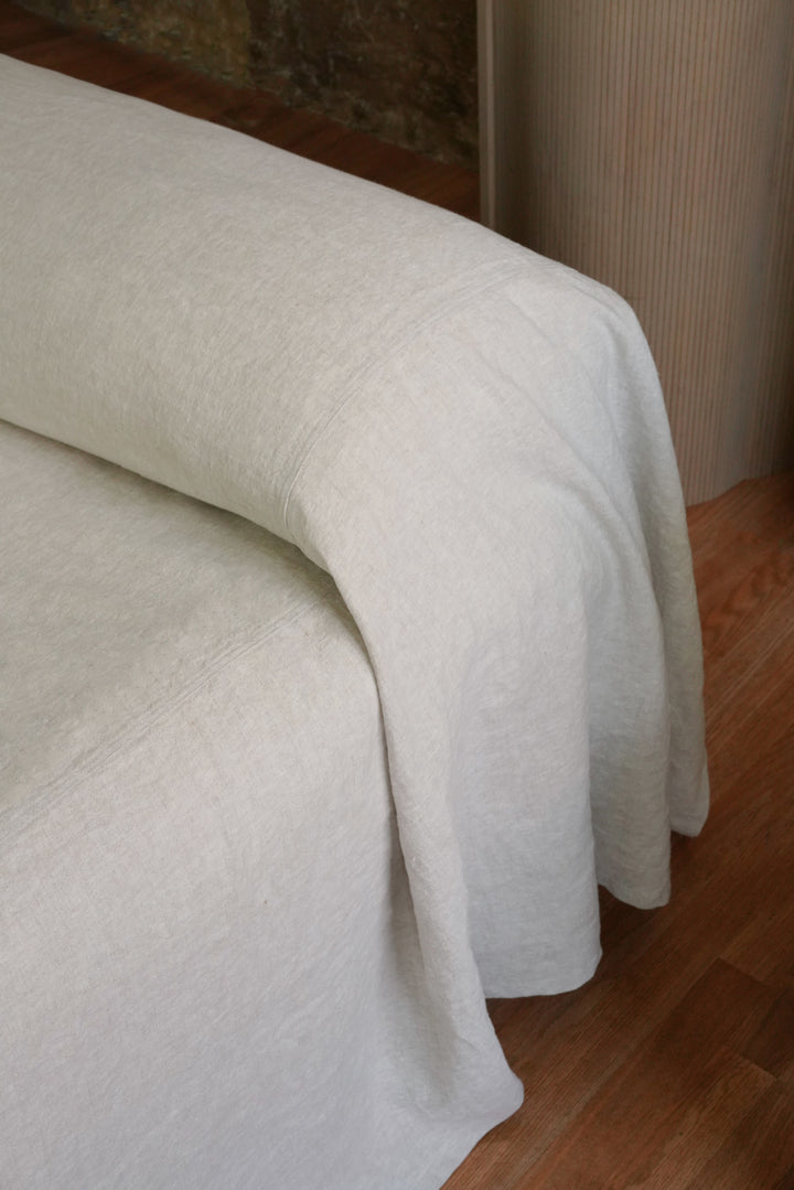 Seamless minimalist edge detail on a heavyweight linen coverlet, styled for a modern Japandi bedroom aesthetic