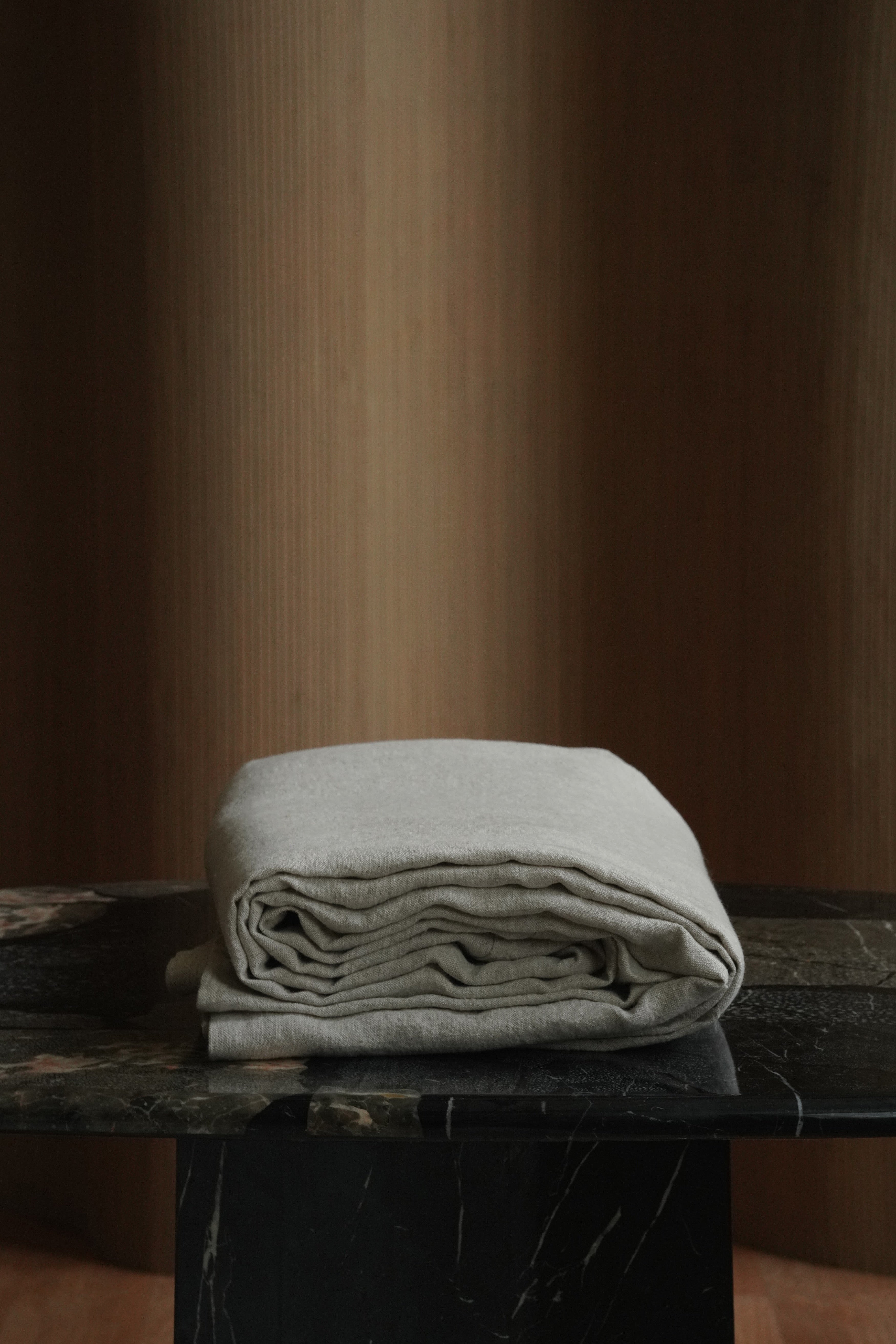 Folded 100% European flax linen bedspread stack highlighting the thick 350 GSM heavyweight weave and natural texture