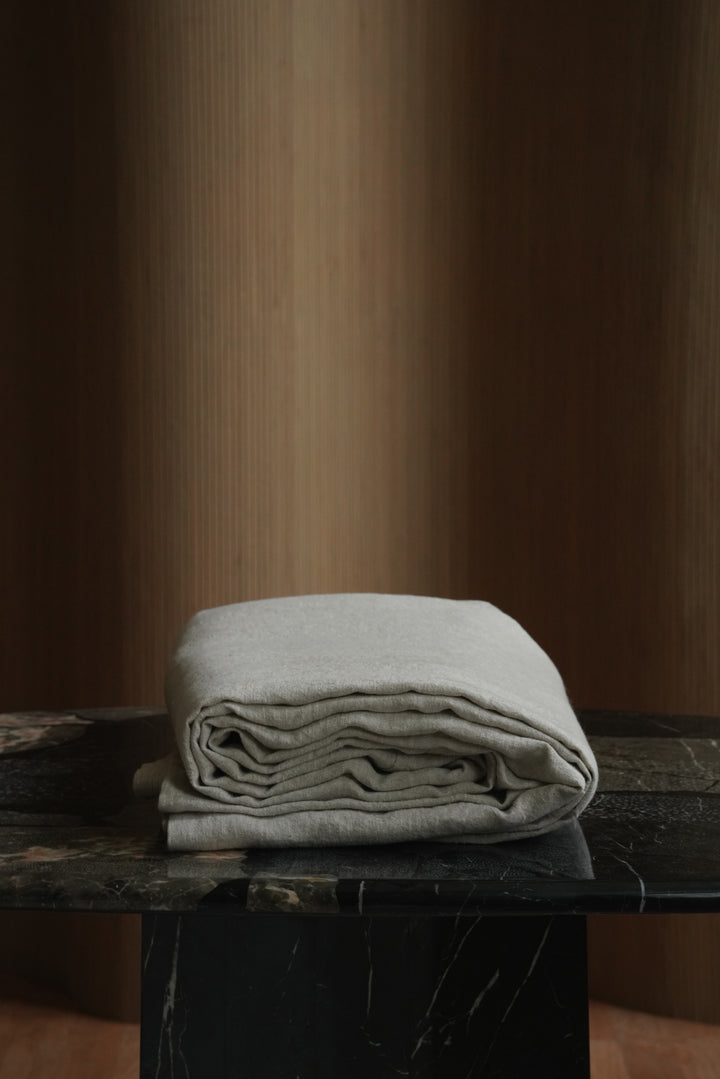 Folded 100% European flax linen bedspread stack highlighting the thick 350 GSM heavyweight weave and natural texture