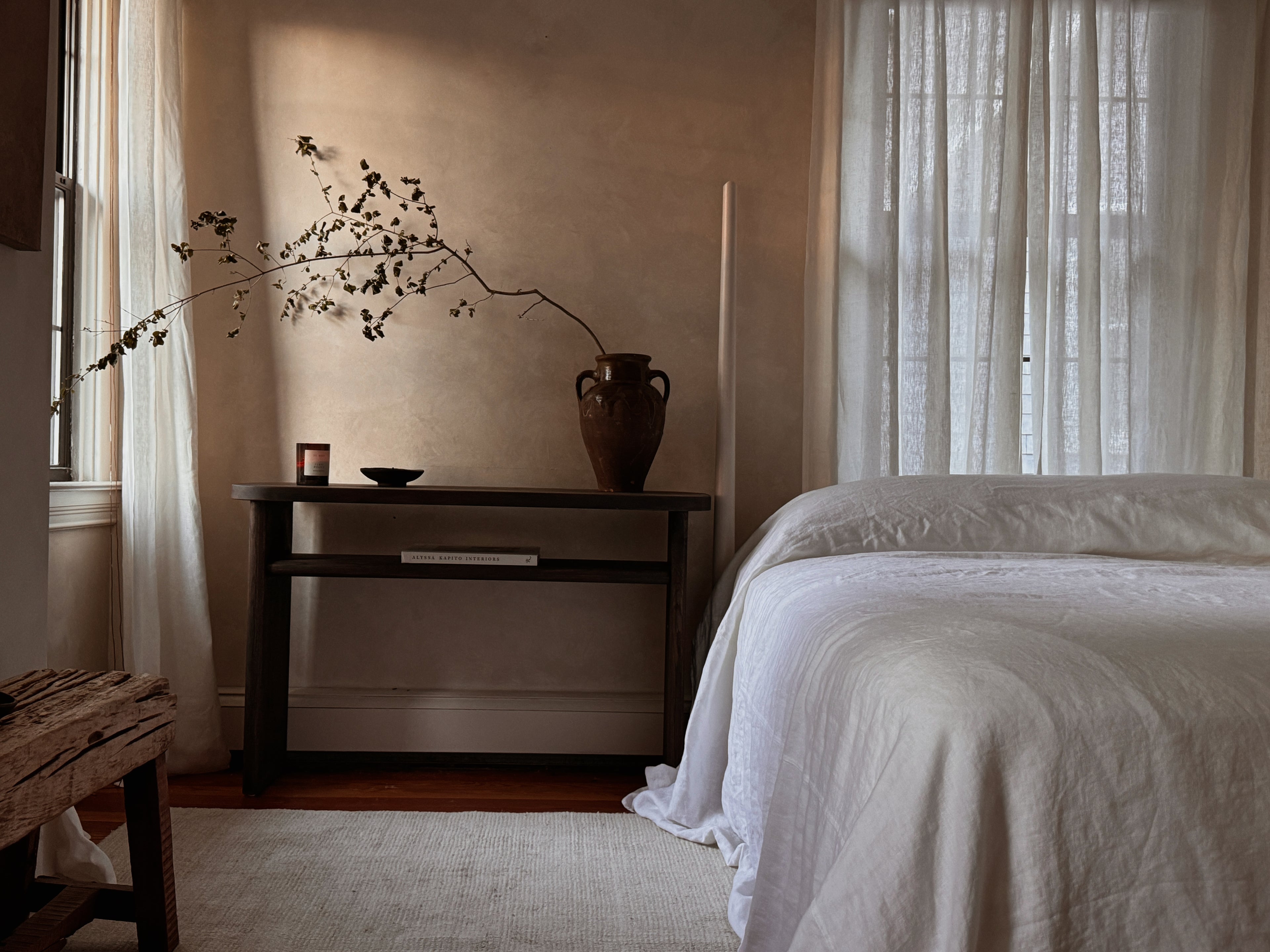 Oversized crisp white 350 GSM heavyweight linen bedspread on a King bed with floor-length luxury puddle drape