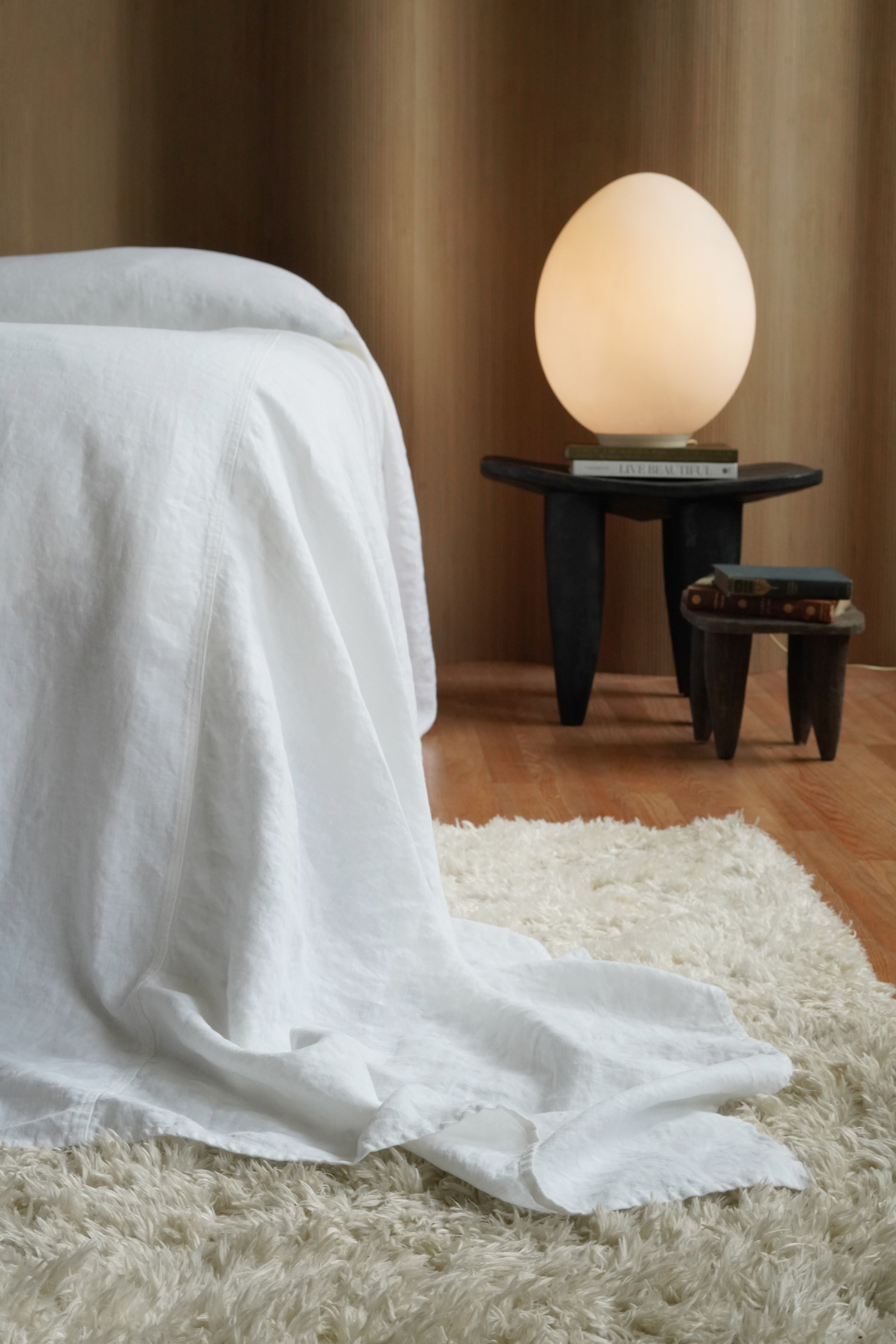 Bright white luxury linen bedspread (124x128) providing full floor-to-floor coverage on a high-profile mattress